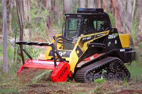 skid steer clearing brush grass and small trees|skid steer forestry drum mulcher.